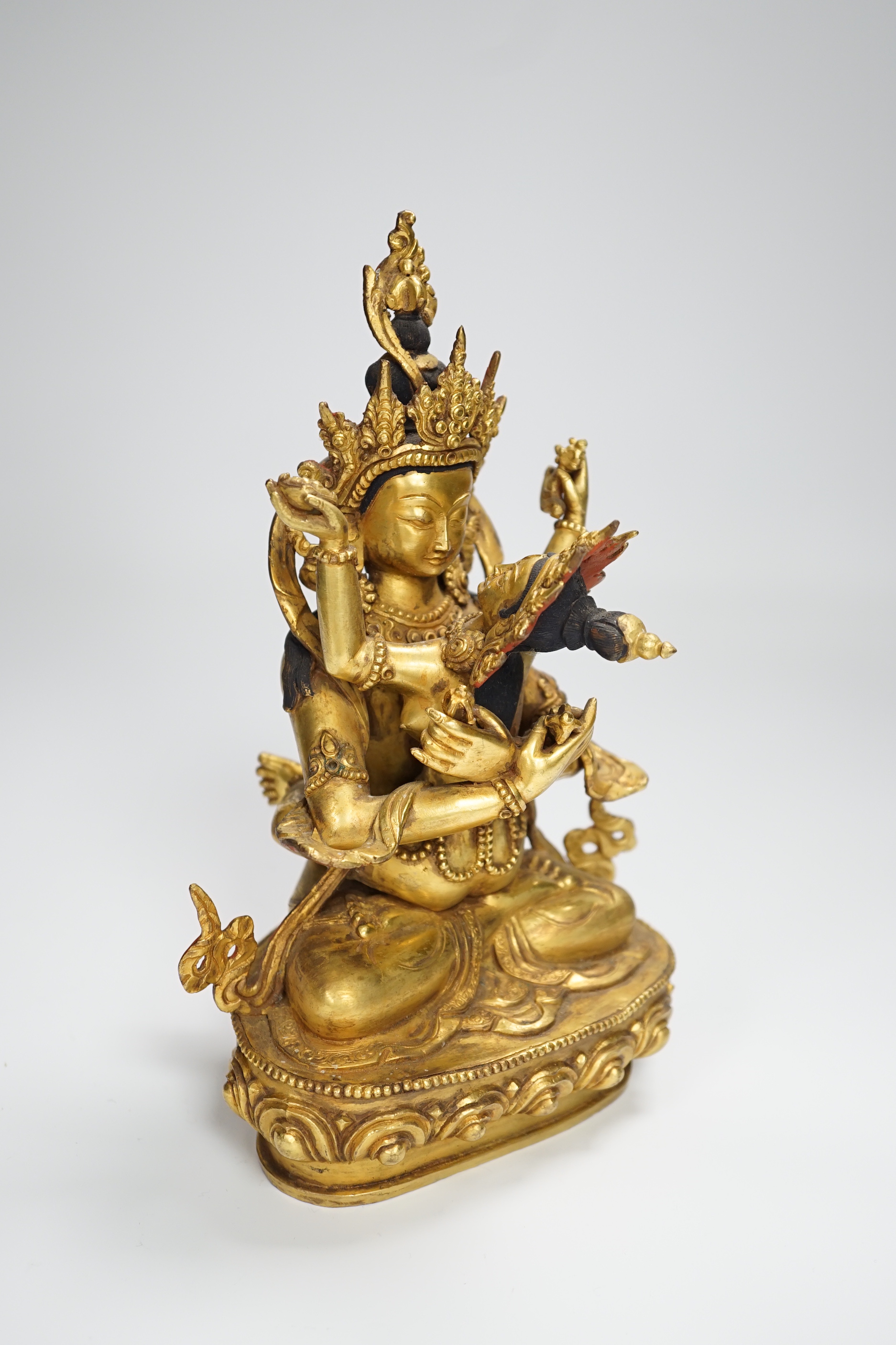 A Sino Tibetan gilt bronze group of a deity with consort, 22.5cm high